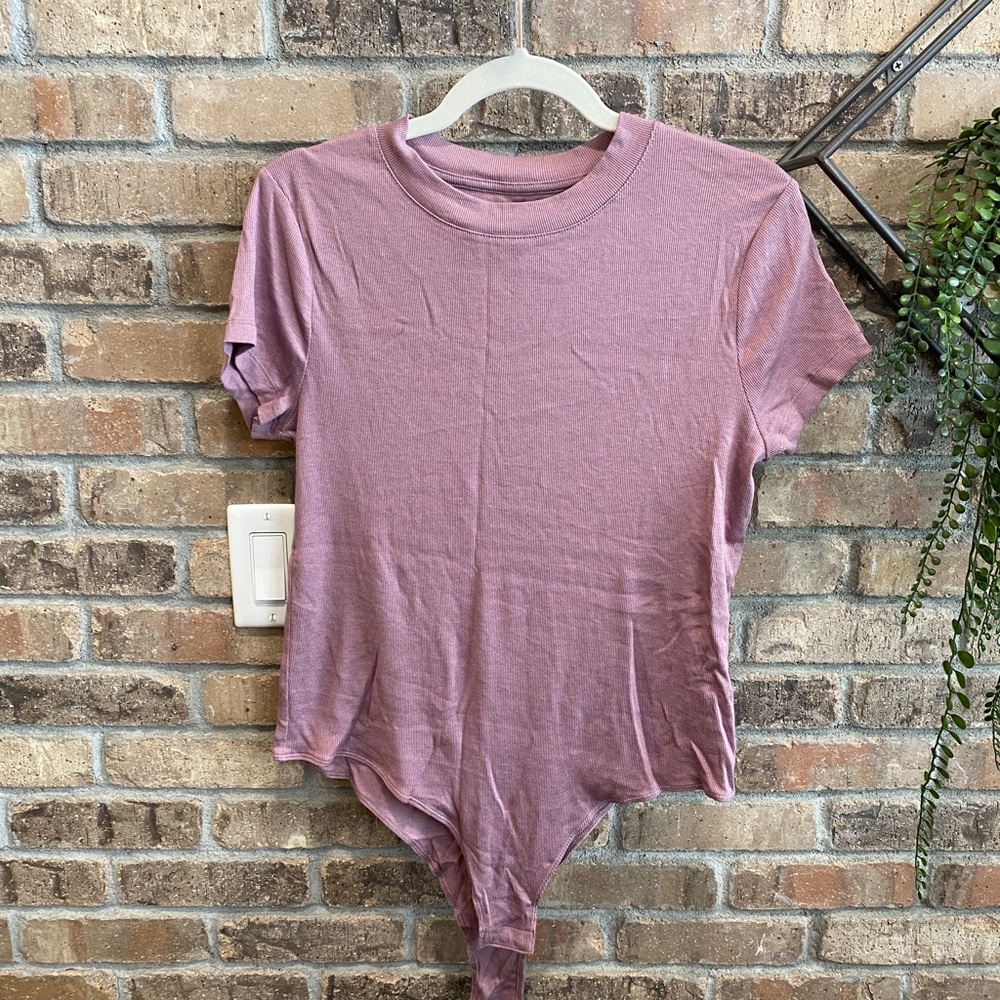 A new day ribbed bodysuit. Brand new missing tag. Size large.
